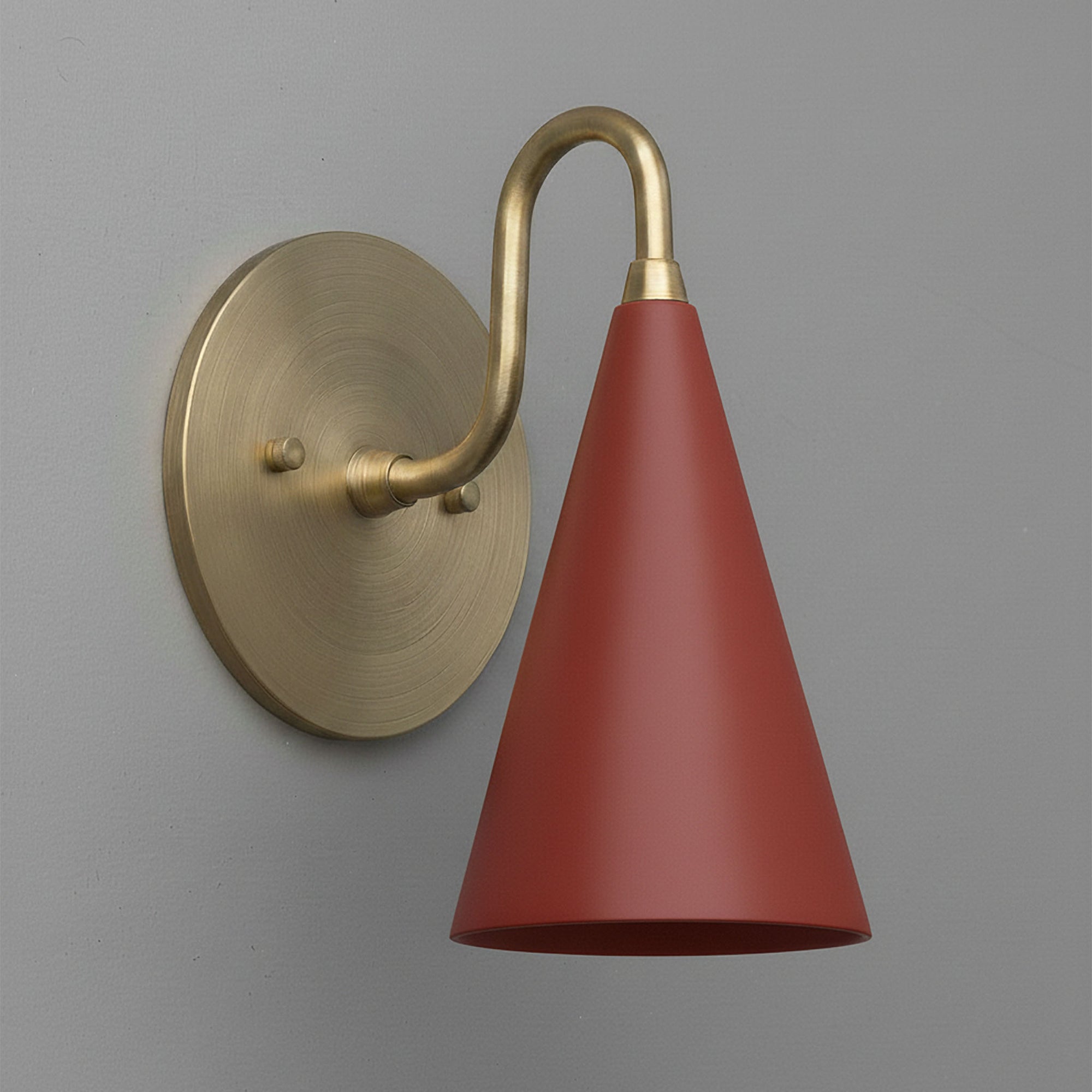 Antique brass sconce with a conical brick red metal shade and curved arm mount. - Sconce Model No. 2900