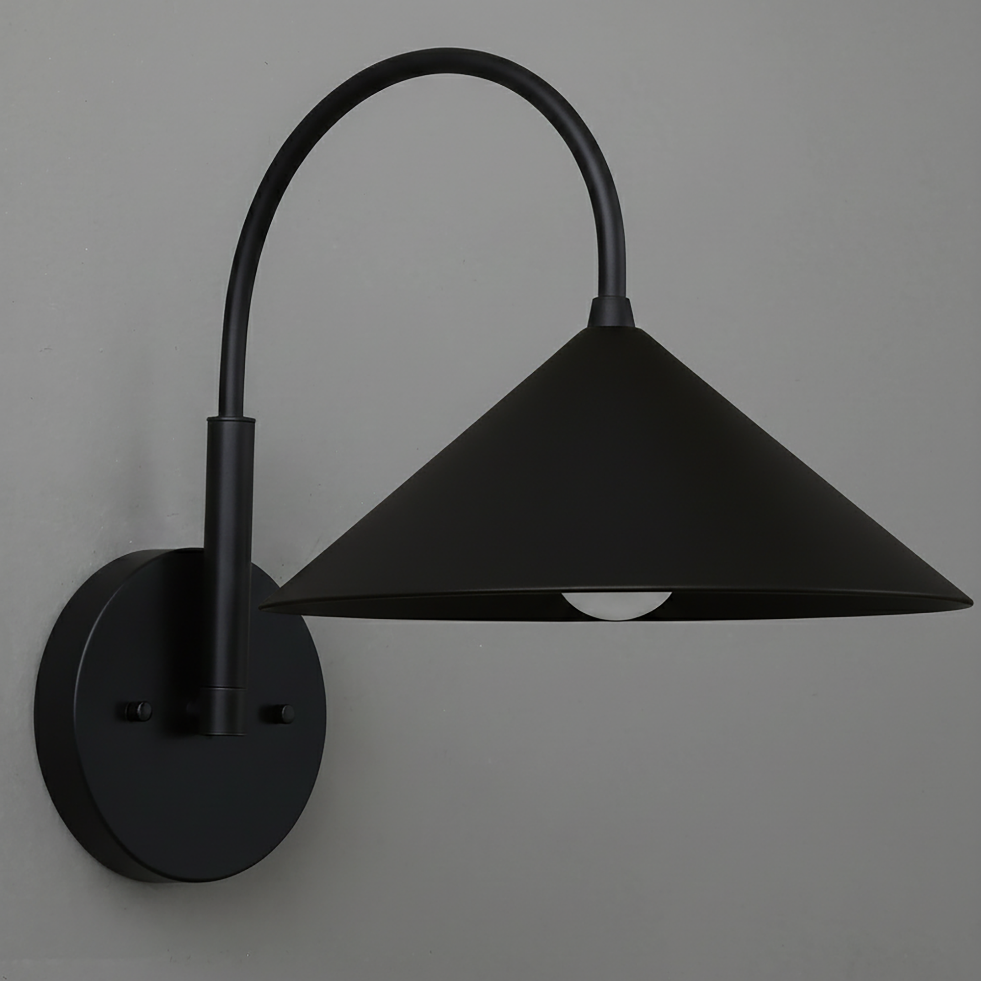 Black metal wall sconce with conical shade and curved arm mounted on round base. - Sconce Model No. 1583