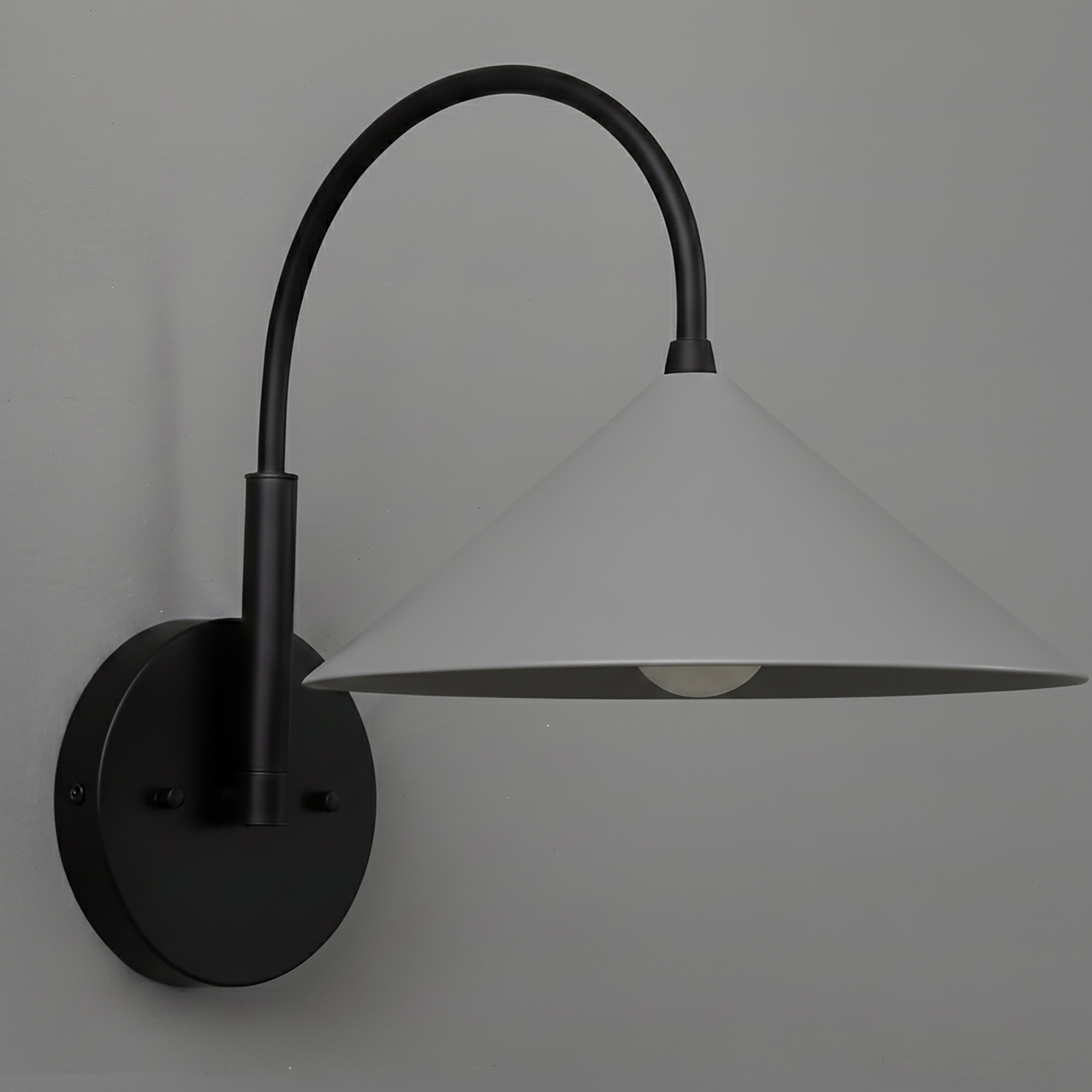 Black metal wall sconce with conical white shade and curved arm mounting on round base. - Sconce Model No. 1583