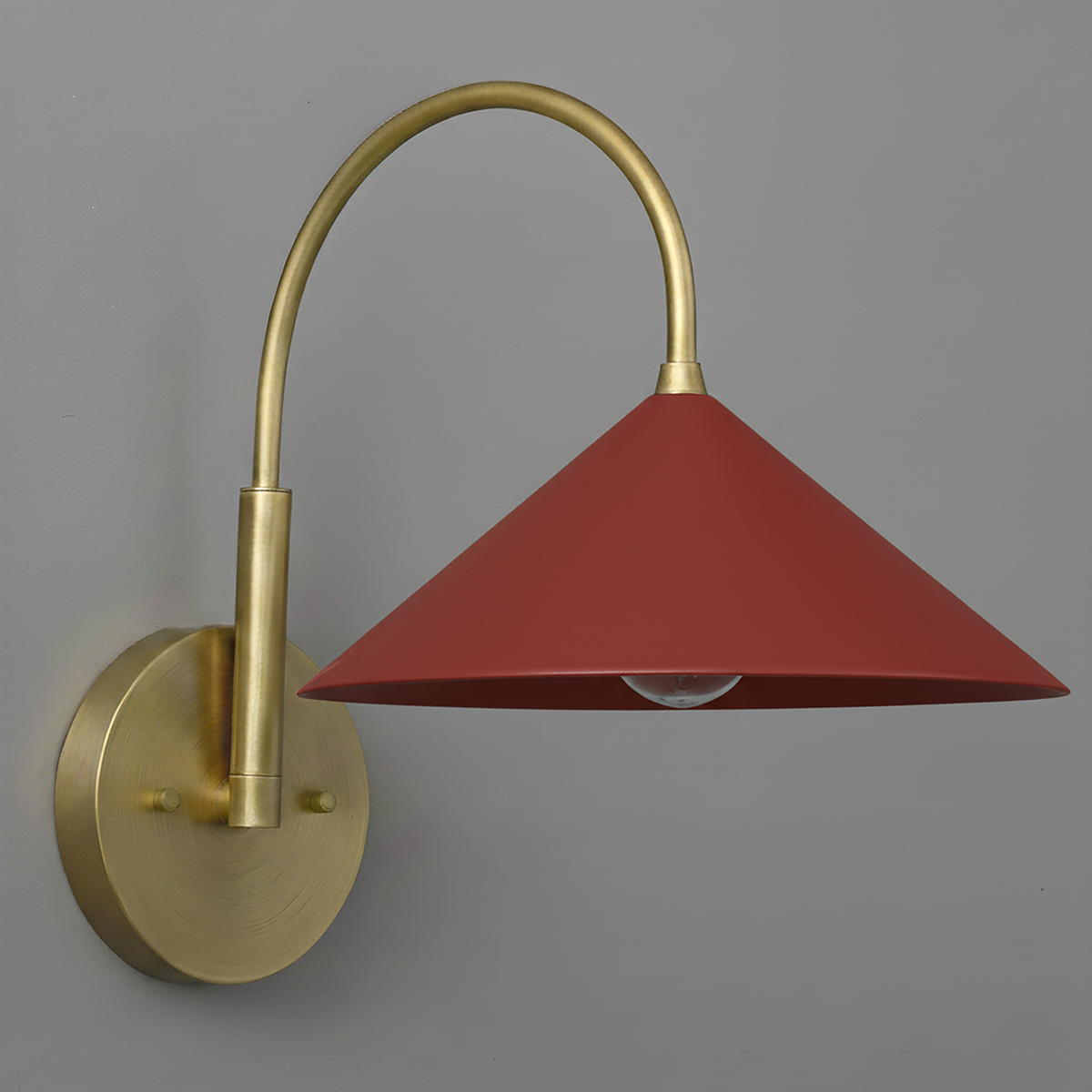 Antique brass wall sconce with curved arm and brick red conical shade. - Sconce Model No. 1583
