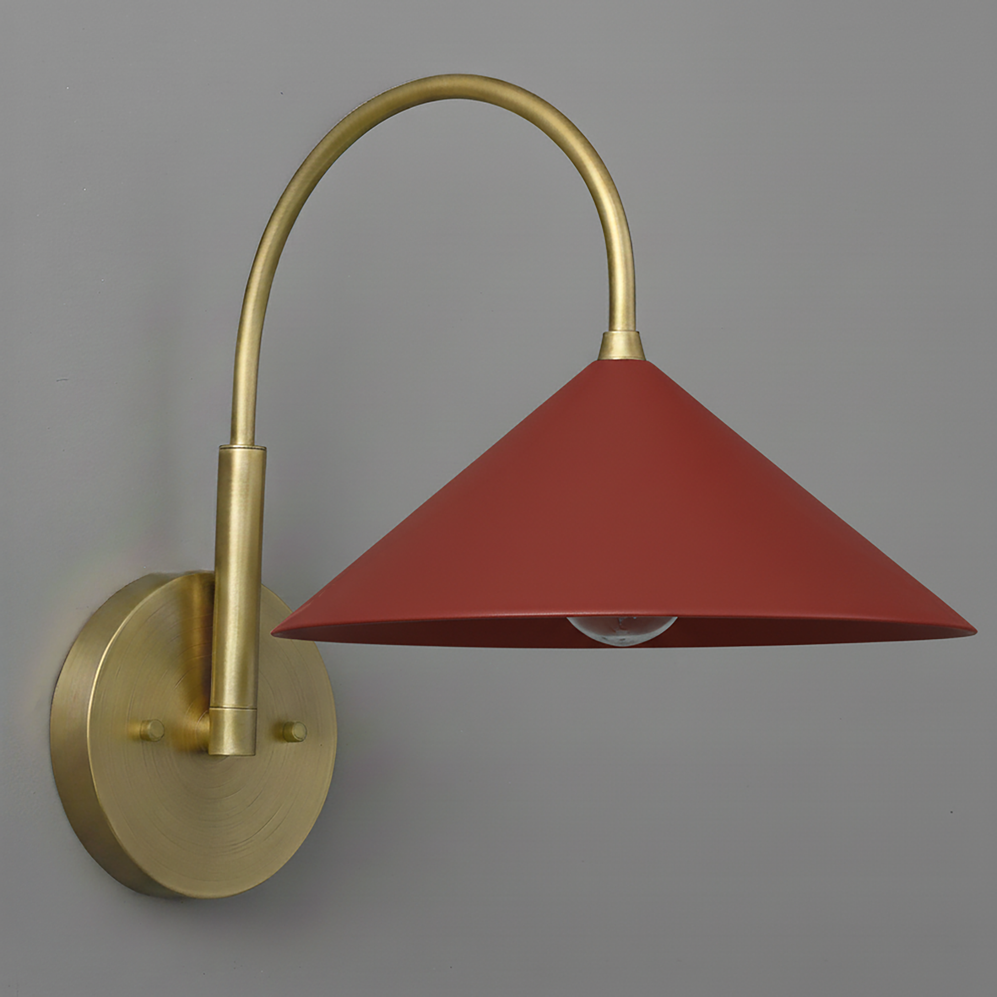 Antique brass wall sconce with curved arm and brick red conical shade. - Sconce Model No. 1583