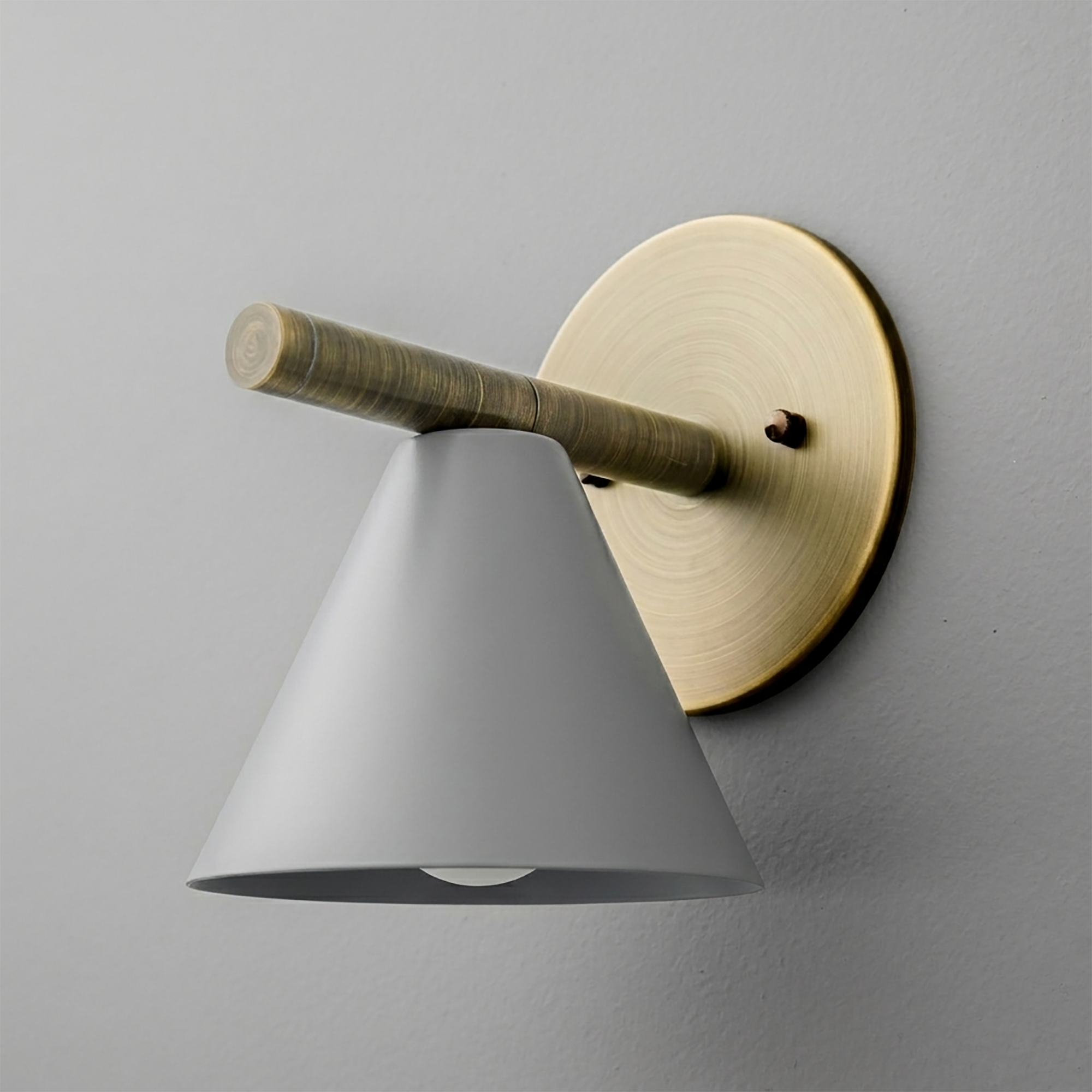 Wall sconce with matte gray conical shade, brass circular backplate, and horizontal brass arm. - SCONCE MODEL NO. 5075