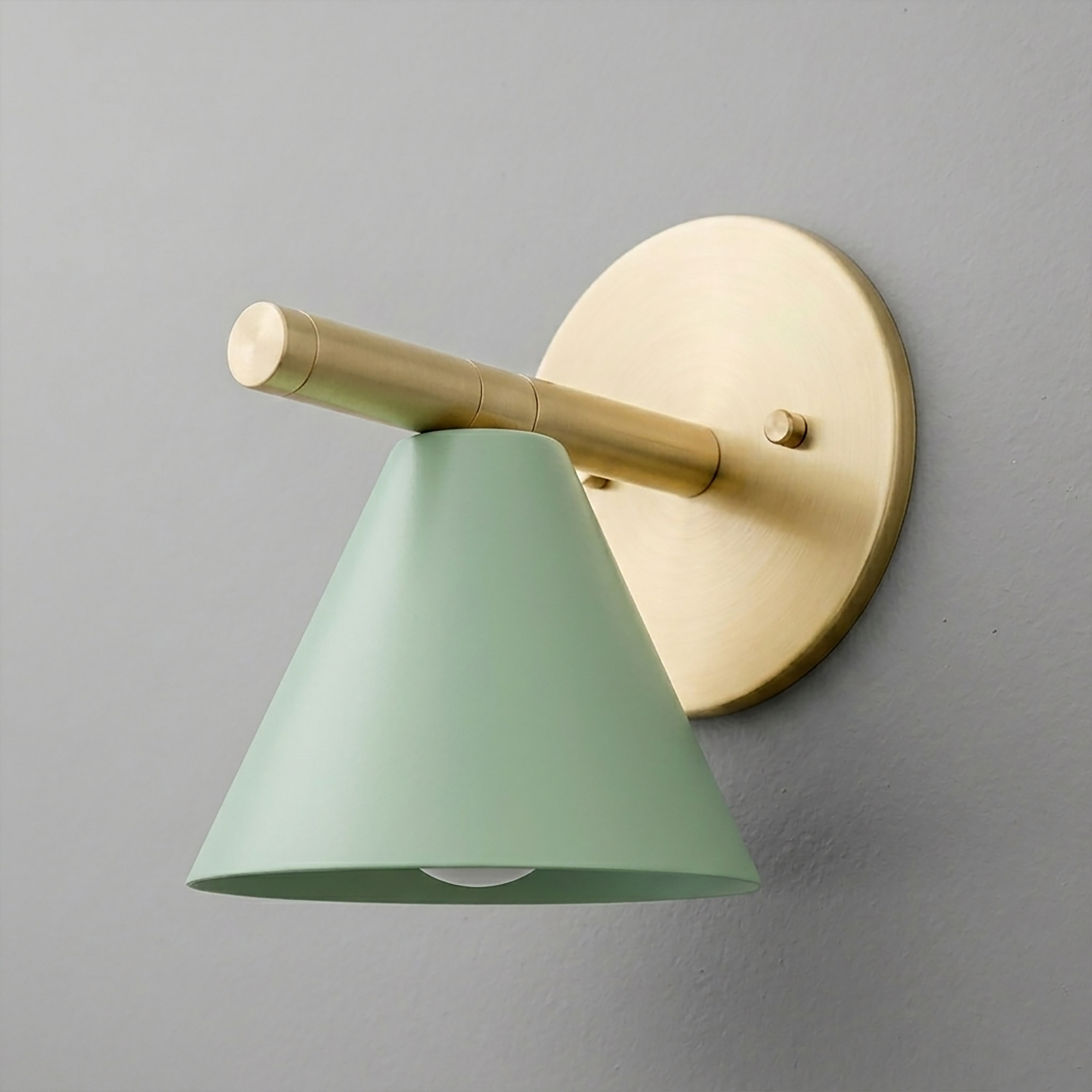Wall sconce with matte brass circular base and arm, featuring a green conical metal shade. - SCONCE MODEL NO. 5075