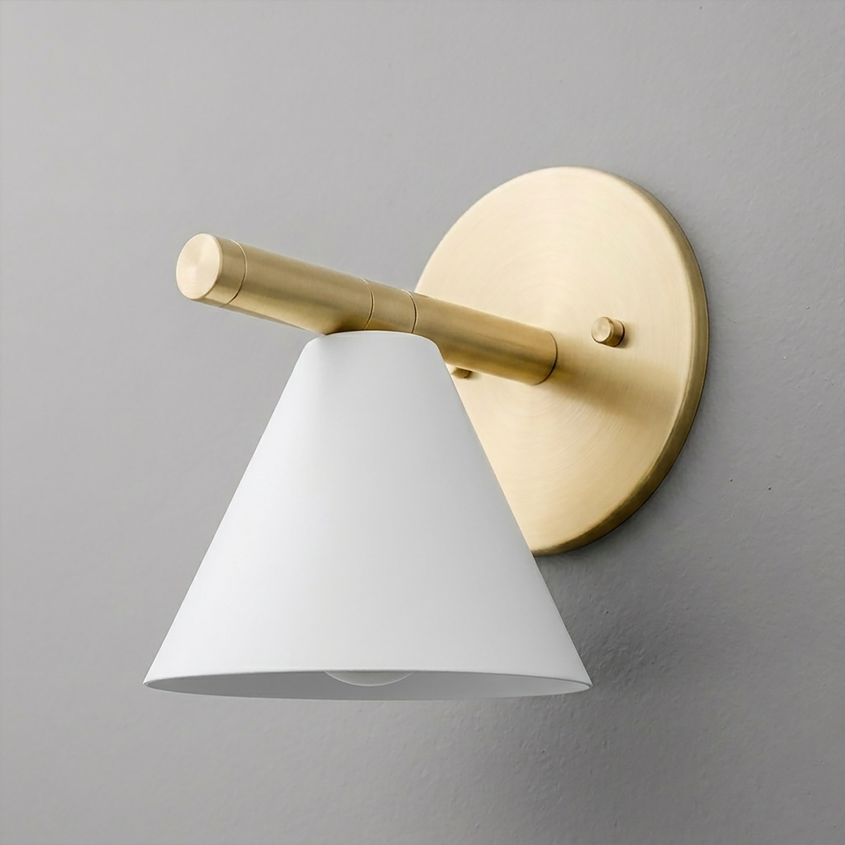 Brushed brass wall sconce with a round backplate and angled white metal cone shade. - SCONCE MODEL NO. 5075