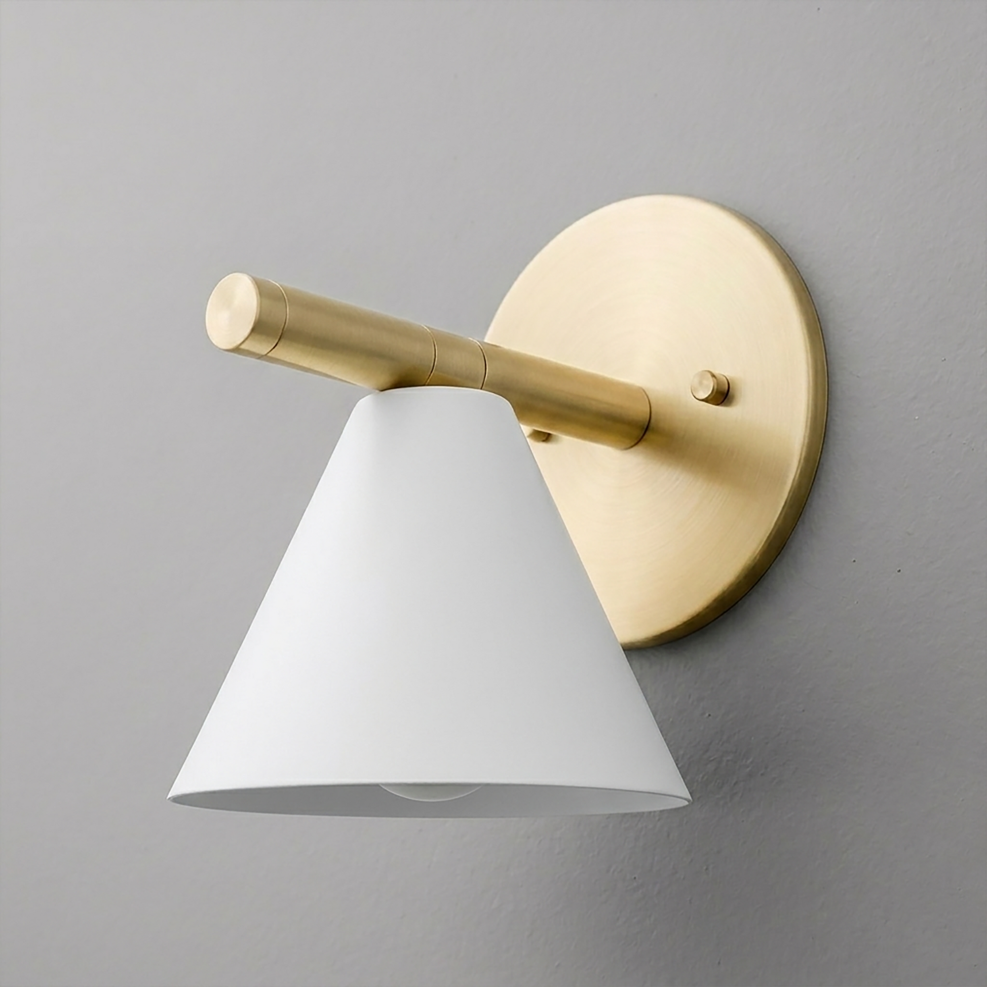 Brushed brass wall sconce with a round backplate and angled white metal cone shade. - SCONCE MODEL NO. 5075