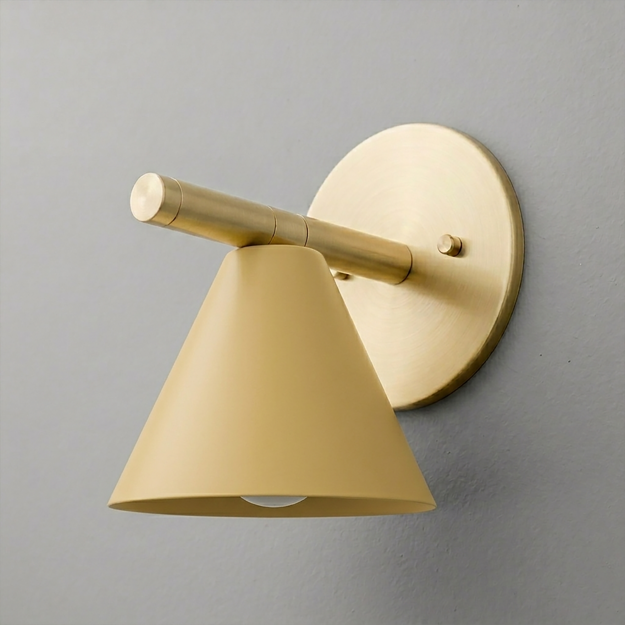Matte gold metal wall sconce with a conical shade and round backplate. - SCONCE MODEL NO. 5075