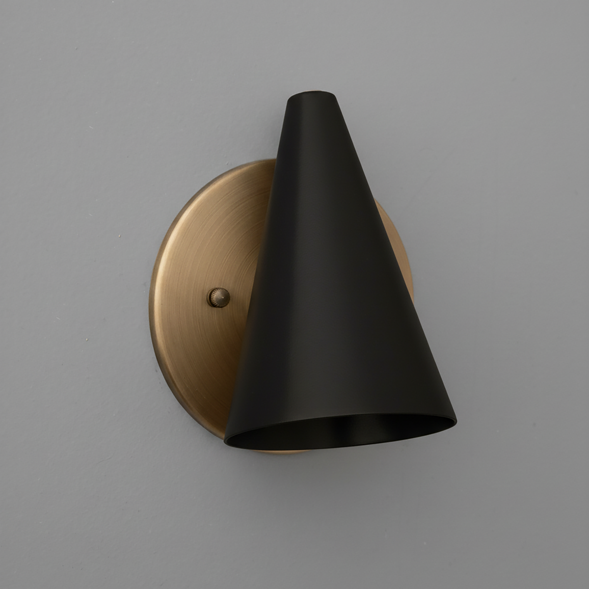Matte black conical metal sconce with brushed brass circular wall mount and single bulb fixture. - SCONCE MODEL NO. 5950