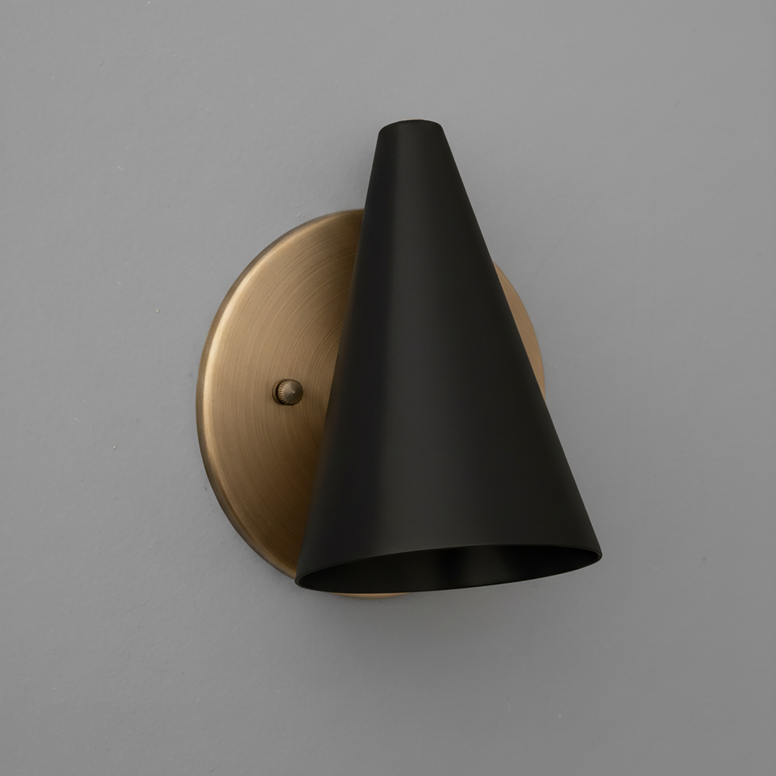 Matte black conical metal sconce with brushed brass circular wall mount and single bulb fixture. - SCONCE MODEL NO. 5950