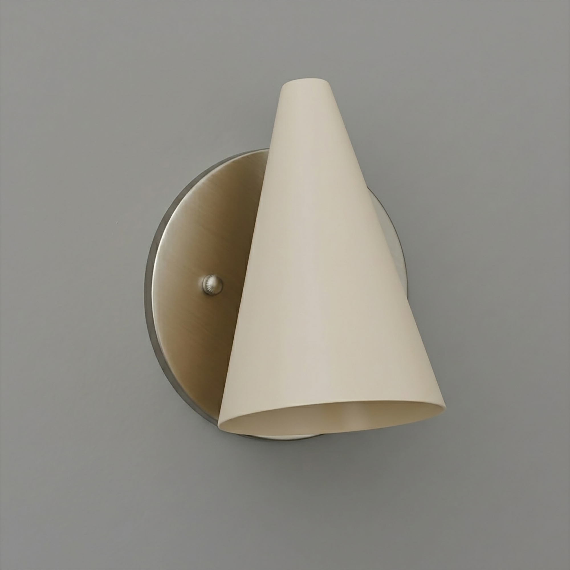 Wall sconce with brushed metal round base and cream-colored conical fabric shade. - SCONCE MODEL NO. 5950