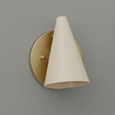 Wall-mounted sconce with a brushed brass circular base and an angled matte cream conical shade. - SCONCE MODEL NO. 5950