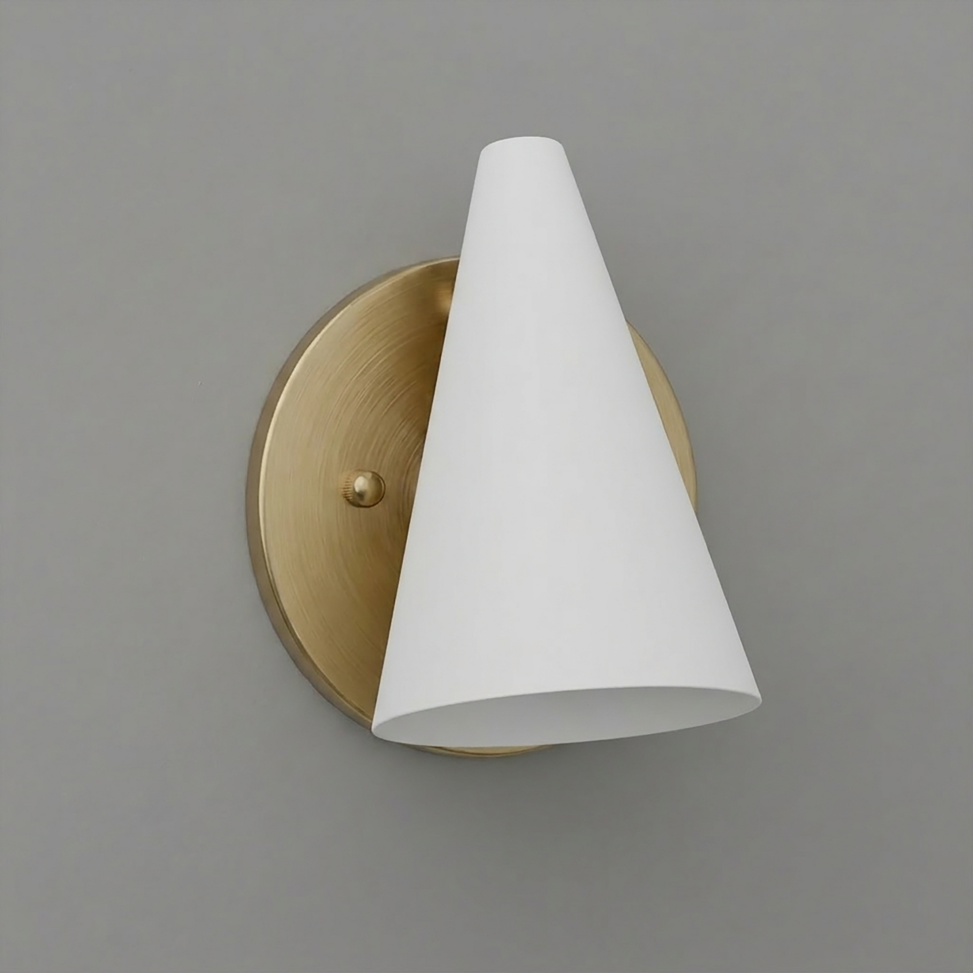 Wall sconce with brushed brass circular base and white conical shade angled downward. - SCONCE MODEL NO. 5950
