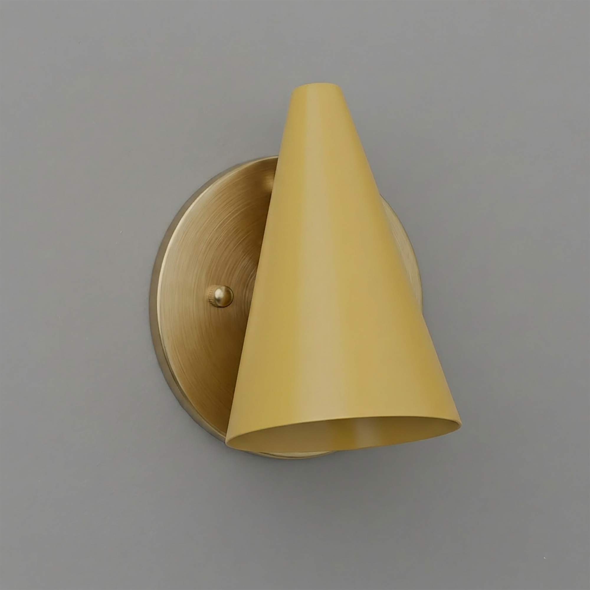 Wall-mounted brass sconce with a conical yellow metal shade and single bulb design. - SCONCE MODEL NO. 5950