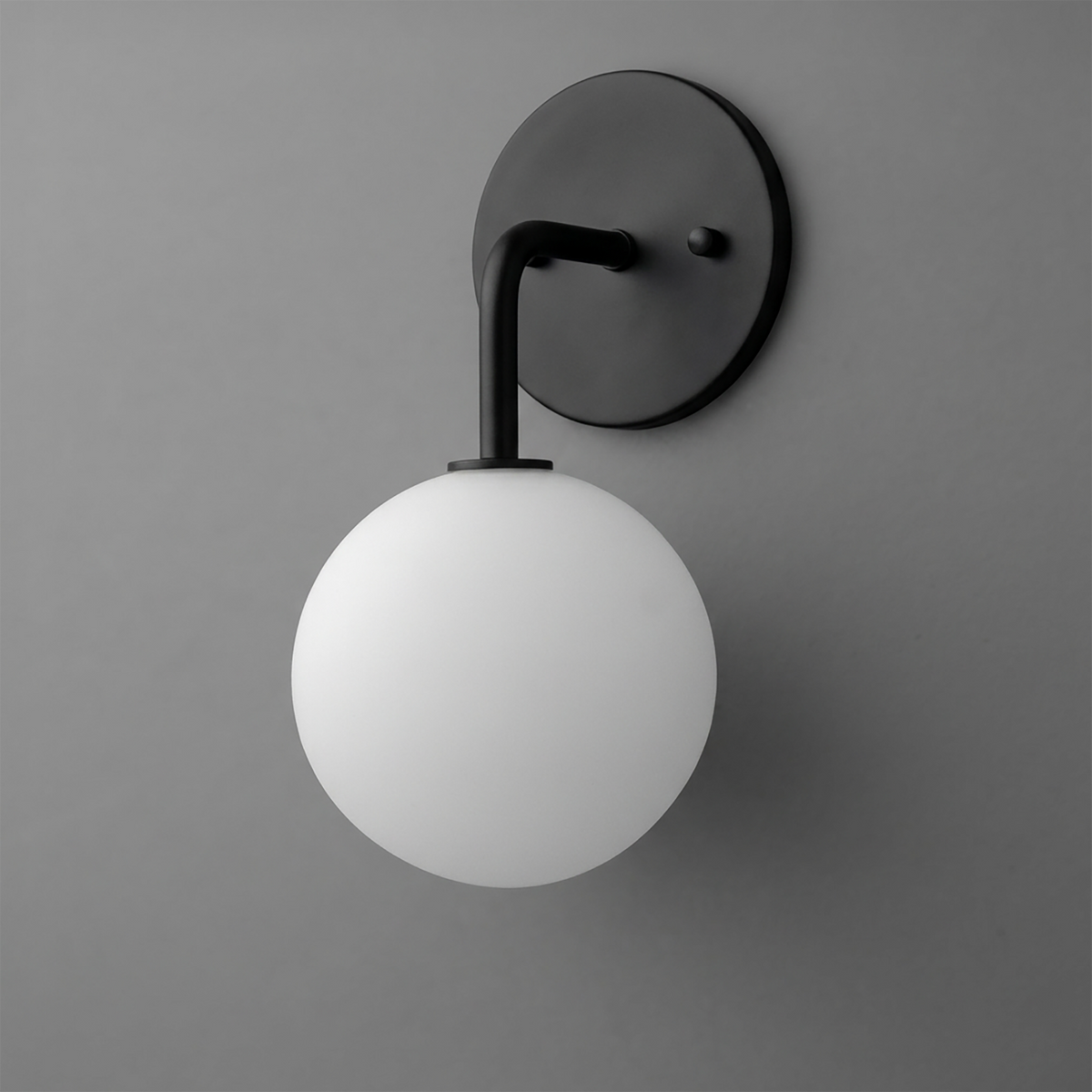 Matte black metal wall sconce with a smooth white glass globe shade and curved arm. - SCONCE MODEL NO. 7660