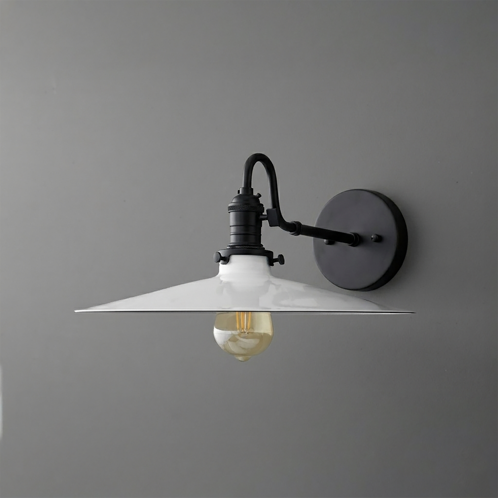 Black metal wall sconce with a wide conical white shade and exposed filament bulb. - SCONCE MODEL NO. 5562