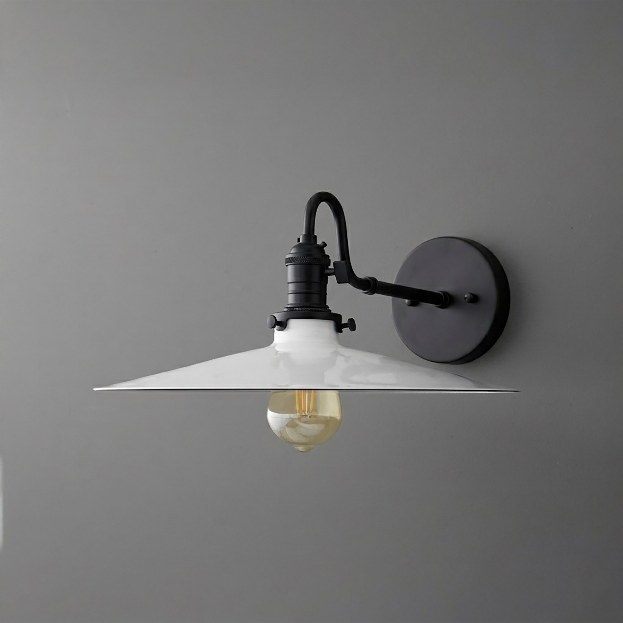 Black metal wall sconce with a wide conical white shade and exposed filament bulb. - SCONCE MODEL NO. 5562