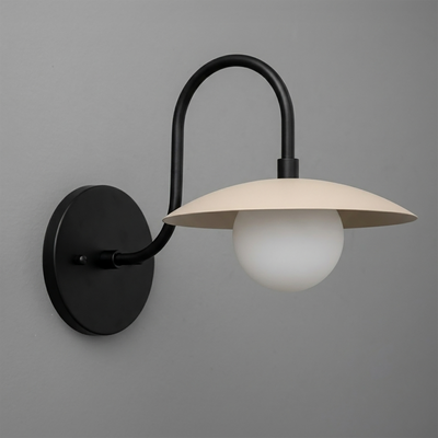 Matte black metal wall sconce with curved arm and cream flat dome shade over white globe bulb. - SCONCE MODEL NO. 3799