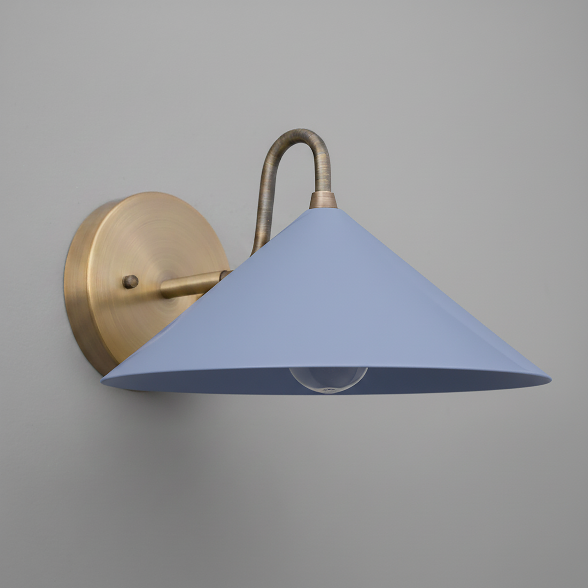 Wall sconce with antique brass mount and curved arm, cone-shaped periwinkle shade. - SCONCE MODEL NO. 6528