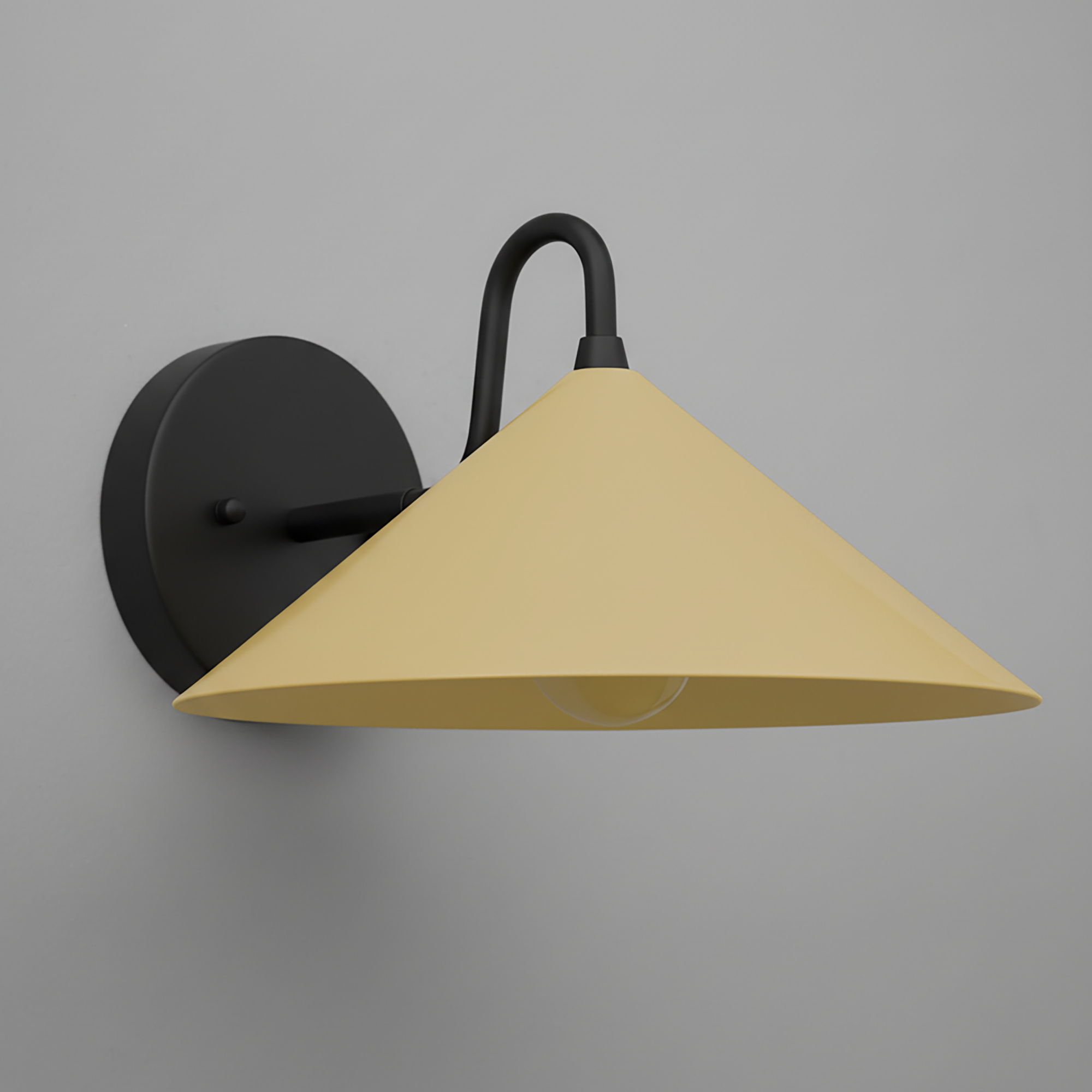 Wall sconce with wide matte yellow metal shade and black curved arm mount on gray wall. - SCONCE MODEL NO. 6528