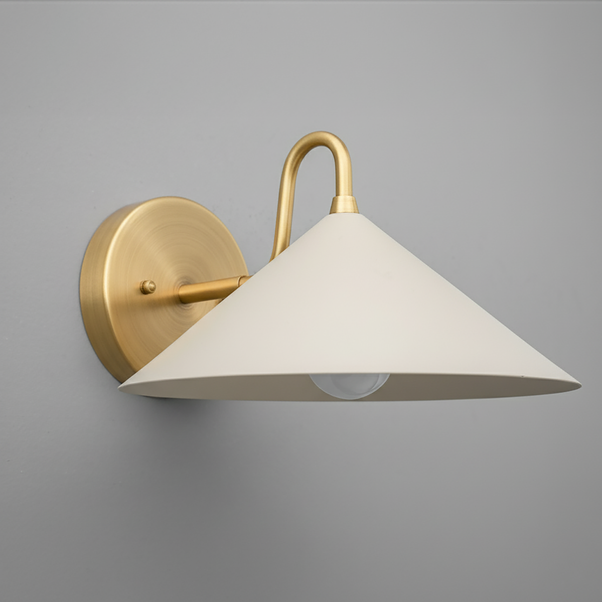 Antique brass wall sconce with wide cream conical metal shade and exposed bulb. - SCONCE MODEL NO. 6528