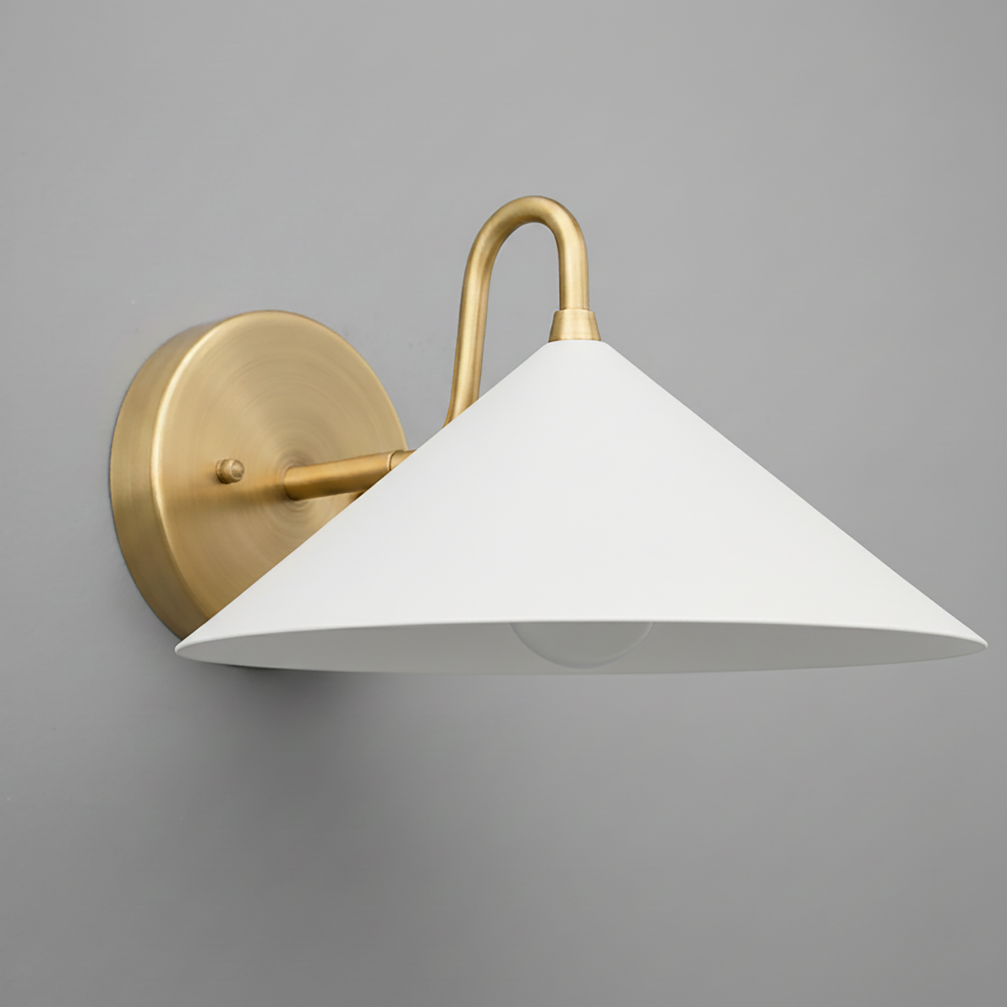Wall-mounted sconce with antique brass finish and wide white conical shade against gray background. - SCONCE MODEL NO. 6528