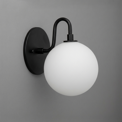 Black metal wall sconce with a smooth curved arm holding a frosted white glass globe shade. - SCONCE MODEL NO. 8637