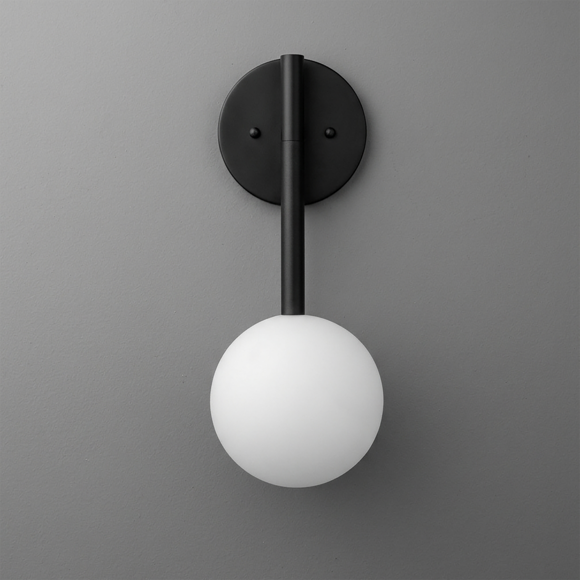 Black metal wall sconce with a vertical rod and a white frosted glass globe light bulb. - SCONCE MODEL NO. 0981