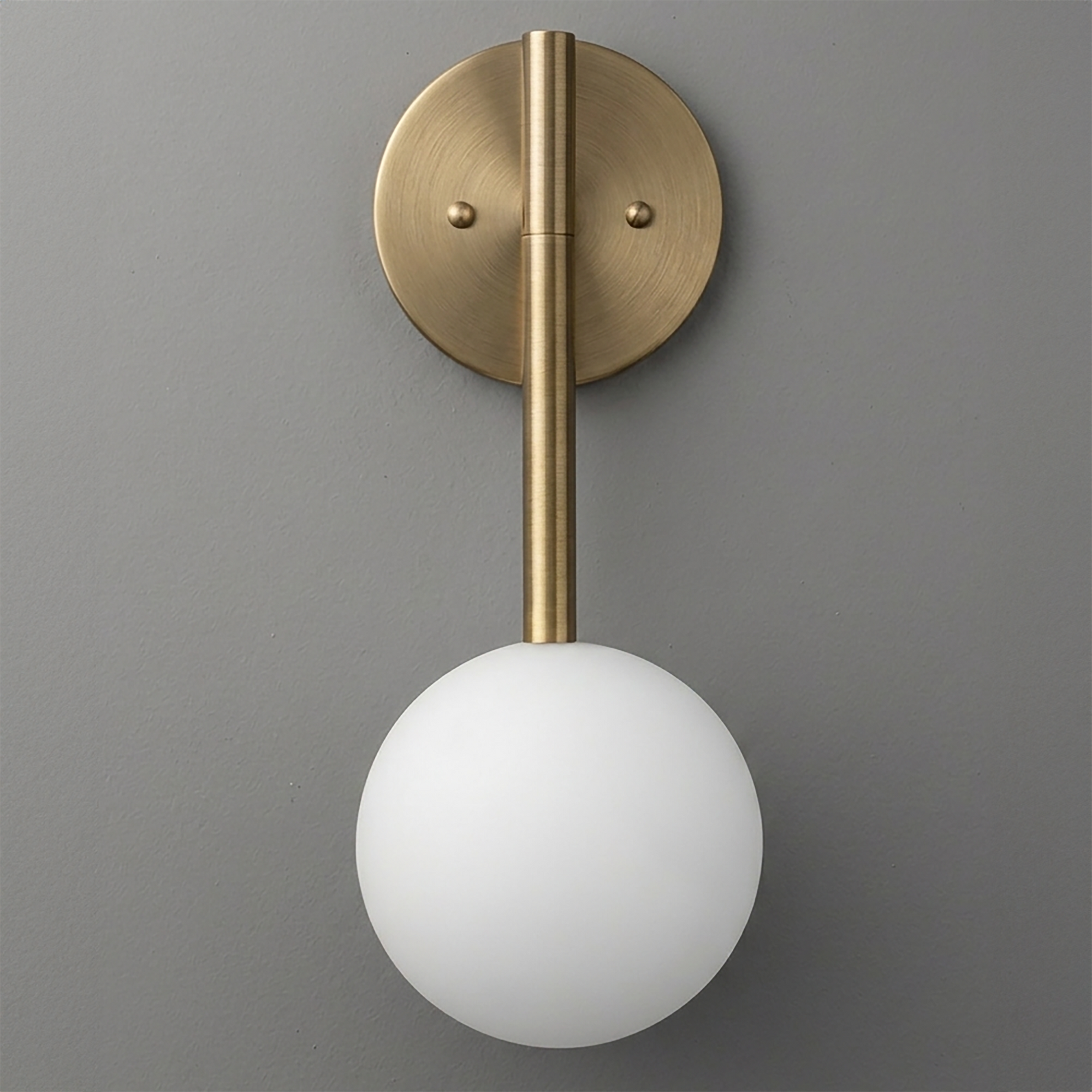 Wall sconce with a round brass backplate and rod supporting a frosted white glass globe shade. - SCONCE MODEL NO. 0981