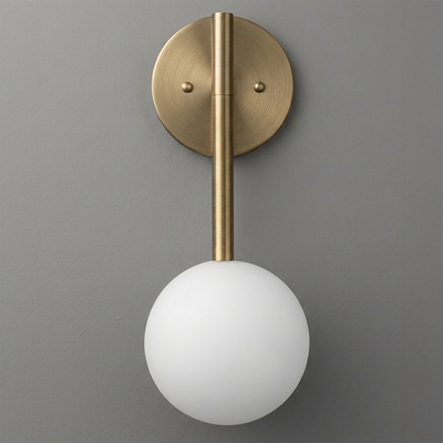 Wall sconce with a round brass backplate and rod supporting a frosted white glass globe shade. - SCONCE MODEL NO. 0981