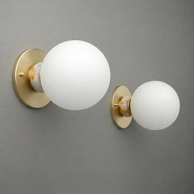 Brushed brass wall sconce with frosted white glass globe shade in two sizes, modern minimalist design. - SCONCE MODEL NO. 1246
