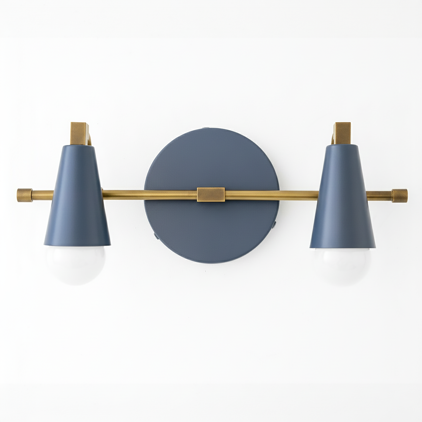 Two-light vanity light with Antique Brass arm and hardware, Coal Blue cone shades and a matching Coal Blue round backplate. - VANITY LIGHT MODEL NO. 1229