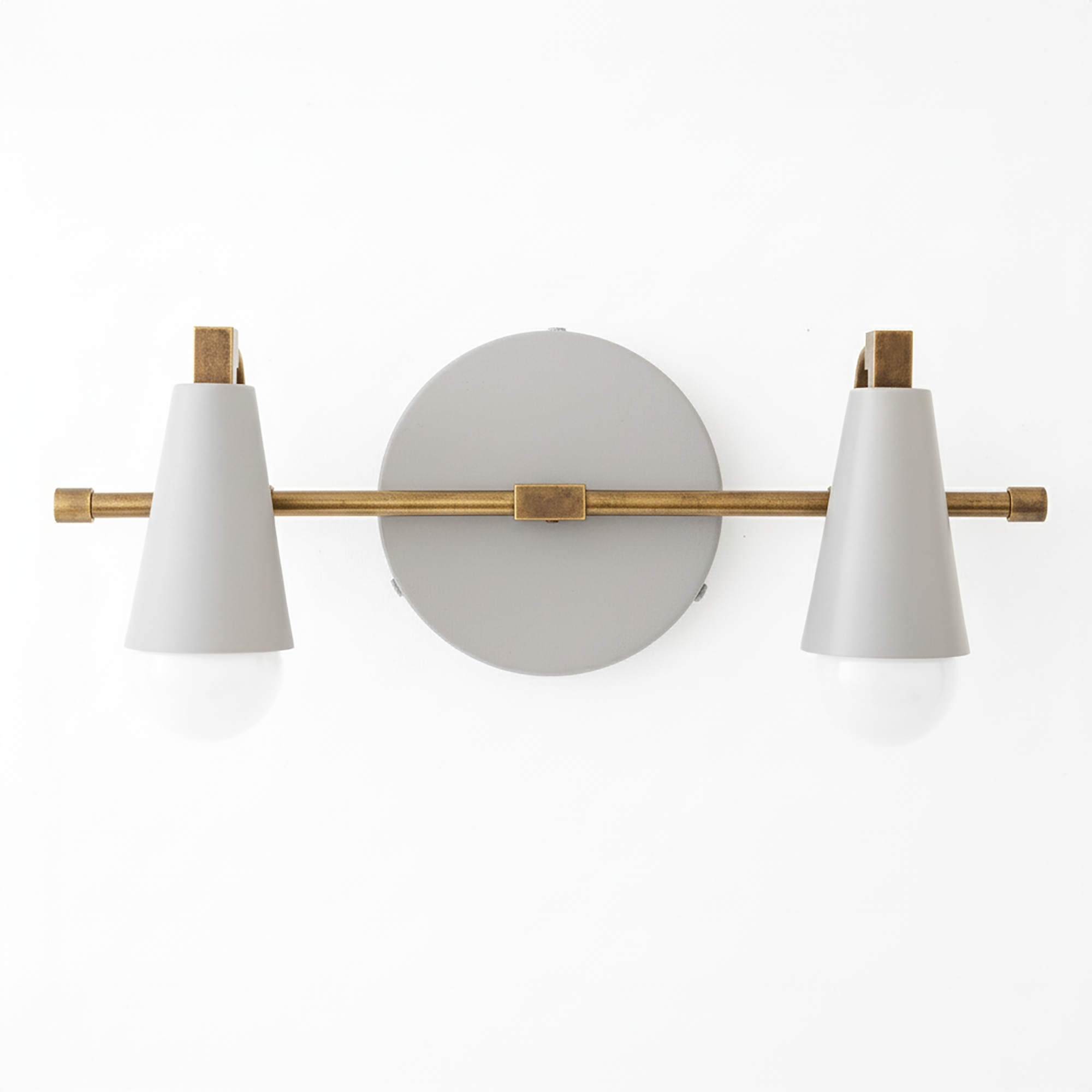 Two-bulb vanity light with matte white conical shades and antique brass horizontal bar on round gray base. - VANITY LIGHT MODEL NO. 1229