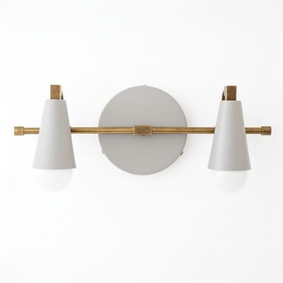 Two-bulb vanity light with matte white conical shades and antique brass horizontal bar on round gray base. - VANITY LIGHT MODEL NO. 1229