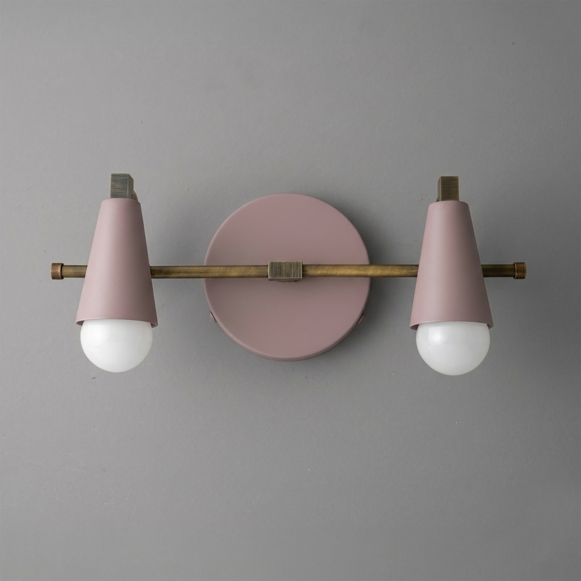 Scandinavian-style 2-bulb vanity light with matte pink cone shades and aged brass horizontal bar mount. - VANITY LIGHT MODEL NO. 1229