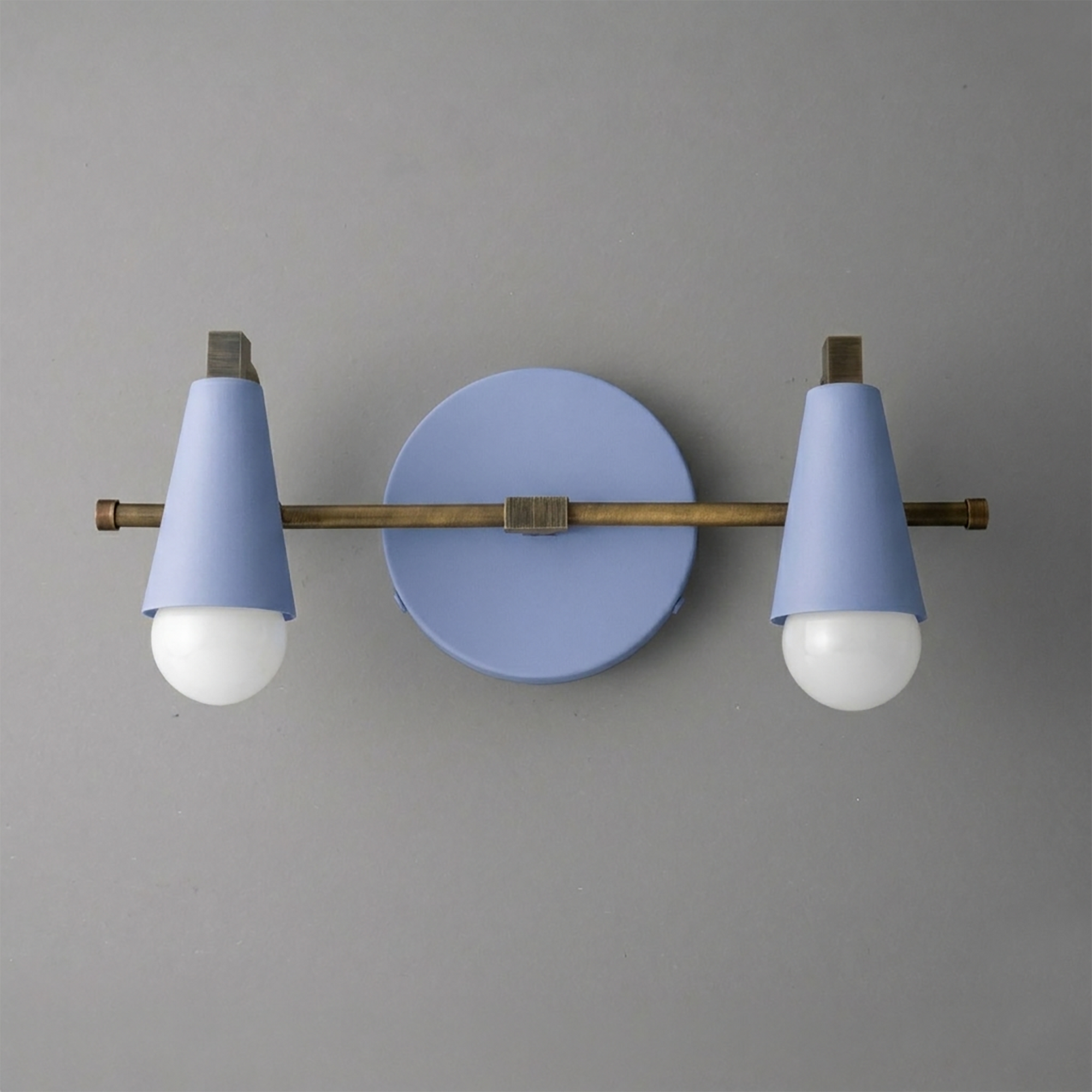 Scandinavian style vanity light with two cone-shaped pastel blue shades and exposed bulbs on a bronze horizontal bar. - VANITY LIGHT MODEL NO. 1229