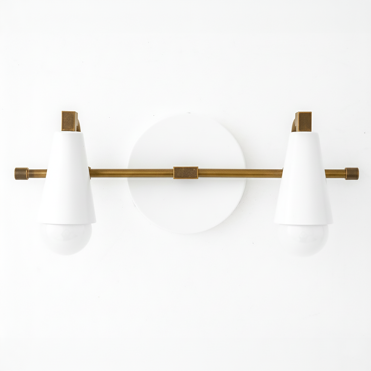 Two-bulb vanity light with white conical shades and antique brass horizontal rod and round white backplate. - VANITY LIGHT MODEL NO. 1229