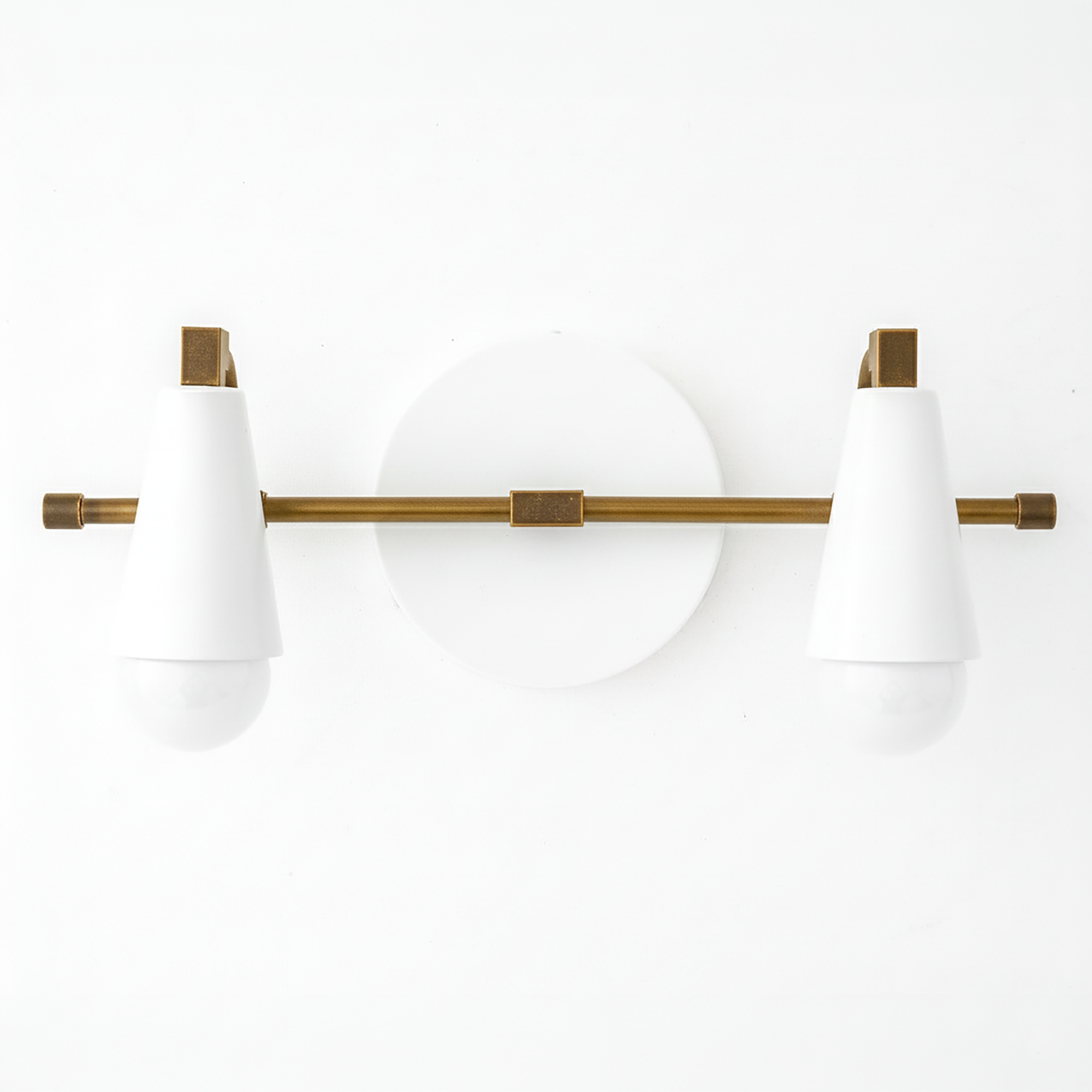 Two-bulb vanity light with white conical shades and antique brass horizontal rod and round white backplate. - VANITY LIGHT MODEL NO. 1229