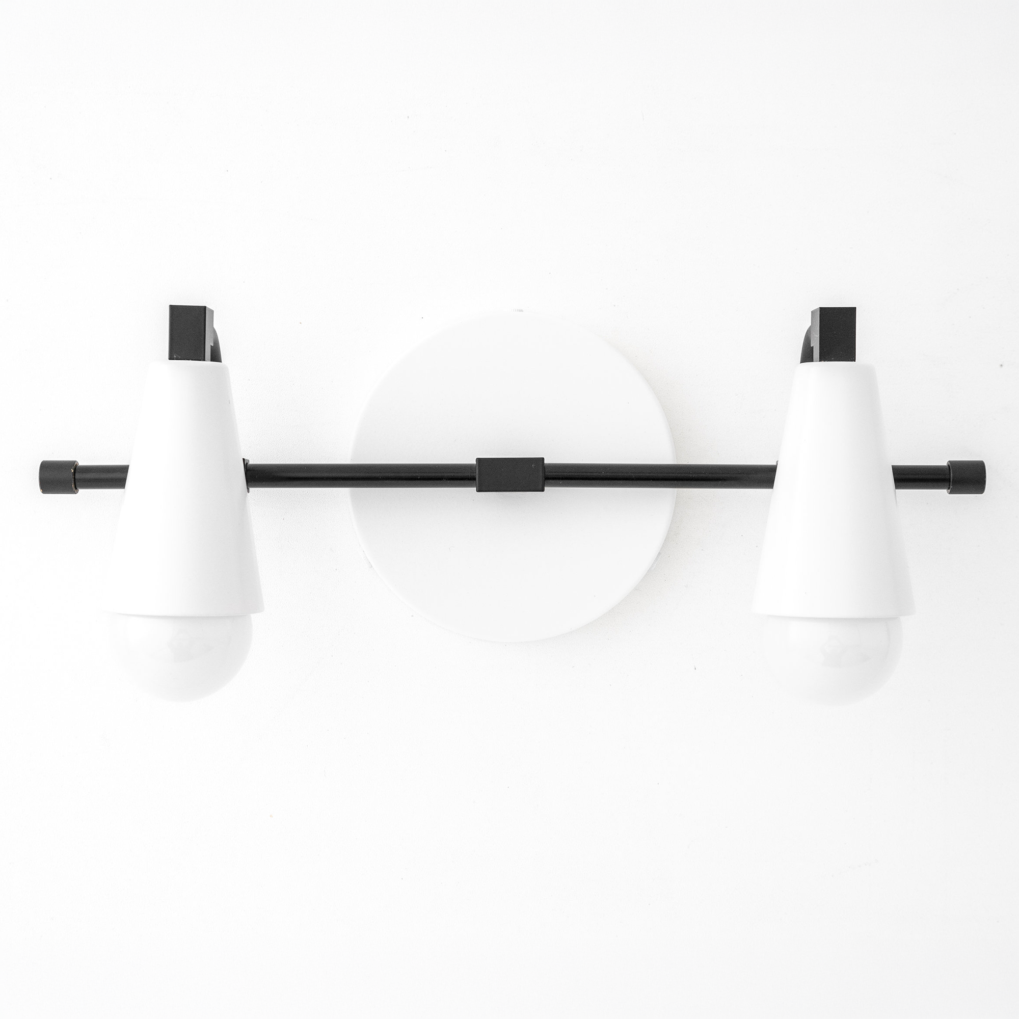 Scandinavian-style white conical shades with exposed bulbs on black horizontal rod vanity light. - VANITY LIGHT MODEL NO. 1229