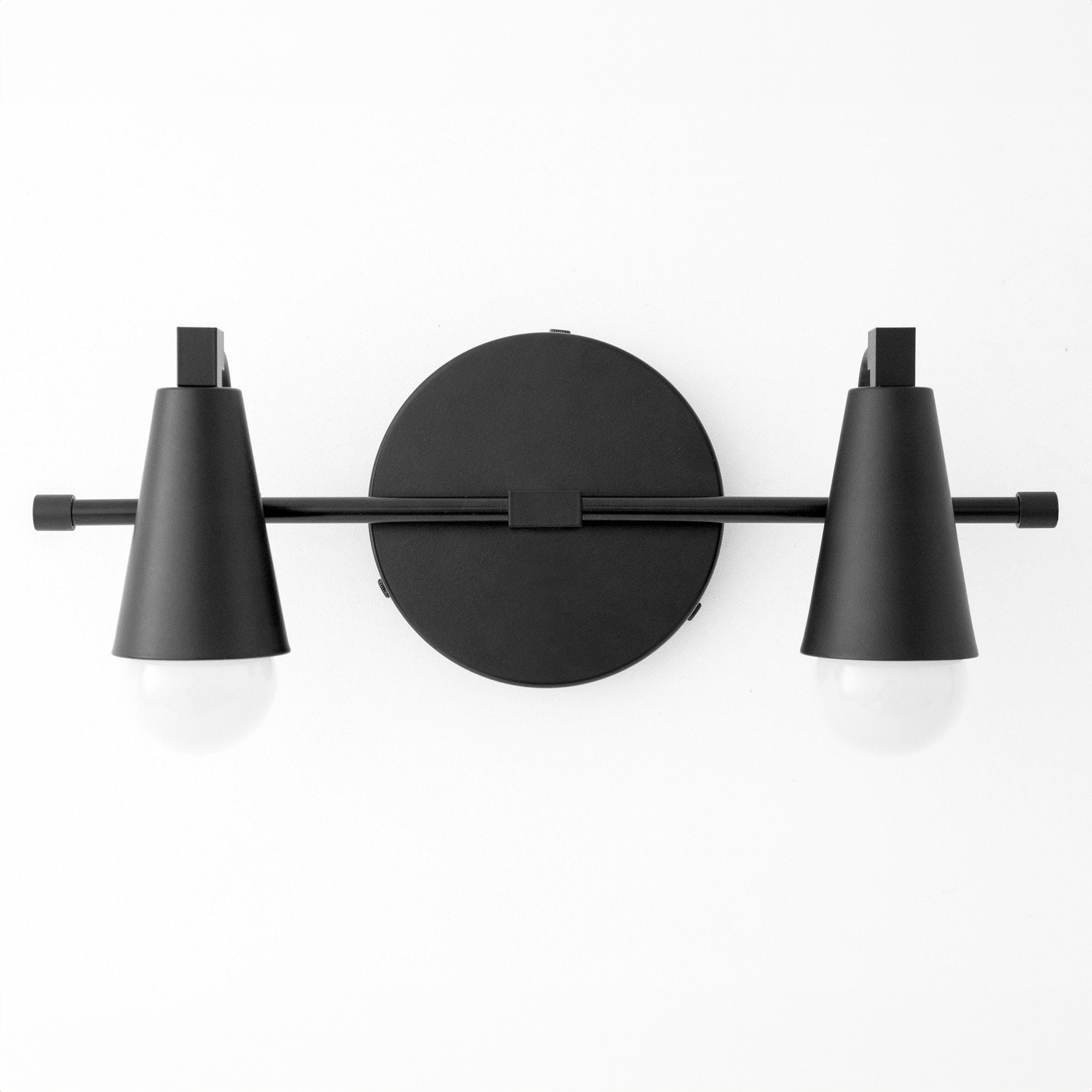 Black metal industrial vanity light with two exposed bulbs and conical shades. - VANITY LIGHT MODEL NO. 1229