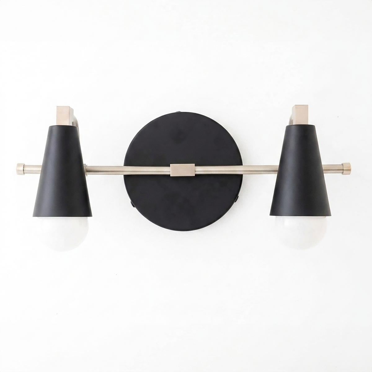 Scandinavian-style 2-bulb vanity light with black conical shades and brushed metal rod mounted on a round black base. - VANITY LIGHT MODEL NO. 1229
