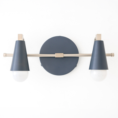 Scandinavian-style vanity light with two exposed round bulbs and matte dark blue conical shades on a brass horizontal bar. - VANITY LIGHT MODEL NO. 1229