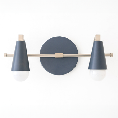Industrial-style vanity light with two bare bulbs, black conical shades, and brass accents. - VANITY LIGHT MODEL NO. 1229