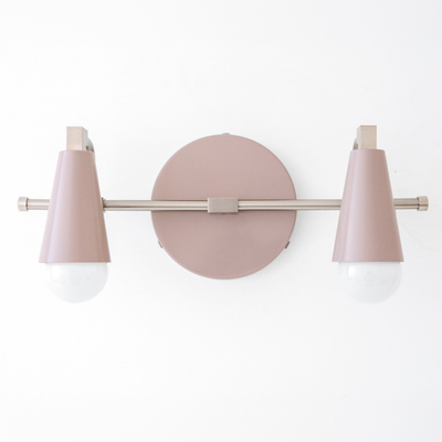 Scandinavian-style vanity light with two pink cone-shaped shades and exposed bulbs on a matte metal bar and round base. - VANITY LIGHT MODEL NO. 1229