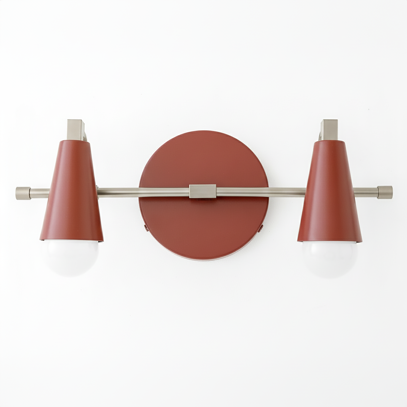 Industrial-style vanity light with two exposed bulbs, matte rust-colored cone shades, and brushed metal horizontal bar mount. - VANITY LIGHT MODEL NO. 1229