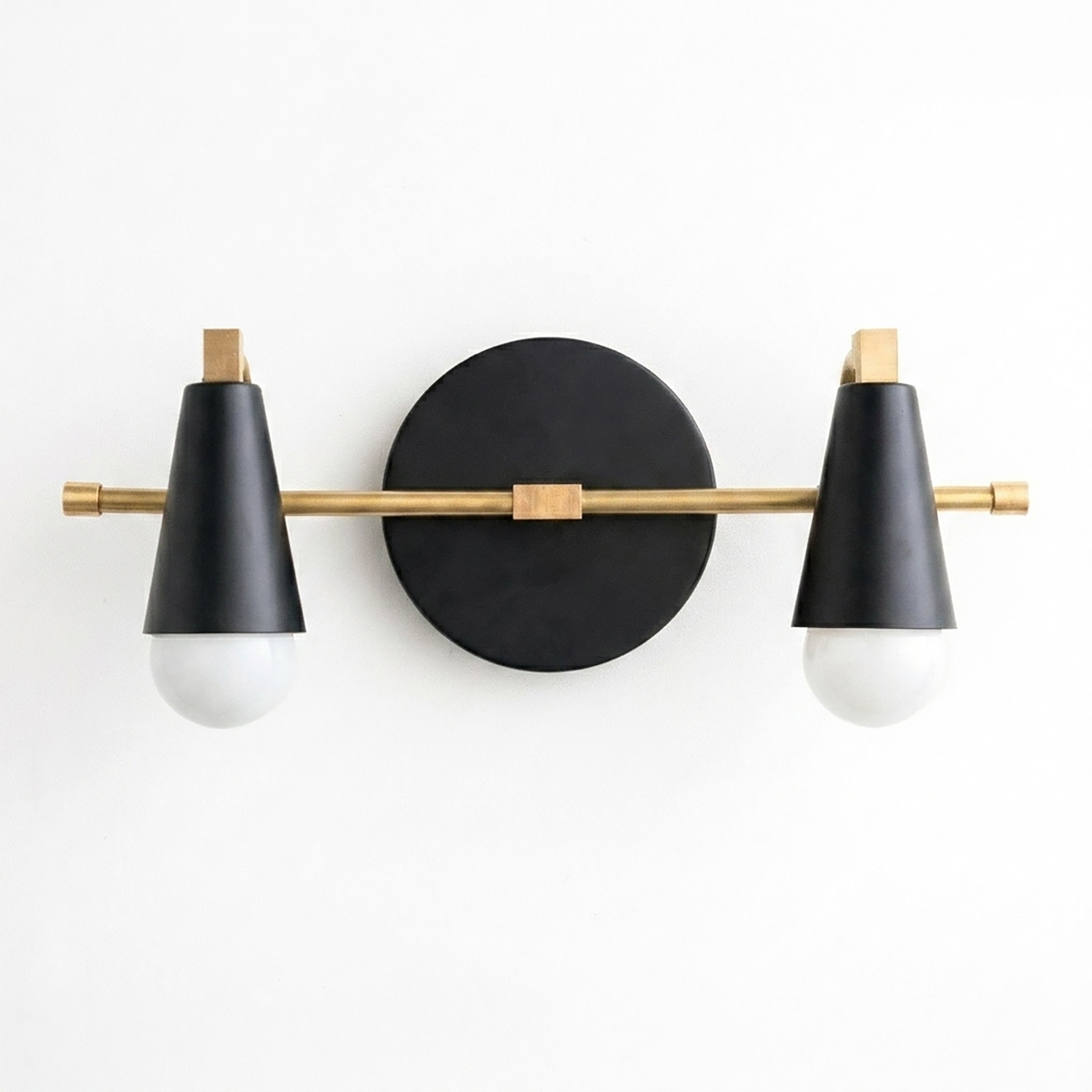 Scandinavian-style two-bulb vanity light with matte black conical shades and brass accents on a round black base. - VANITY LIGHT MODEL NO. 1229