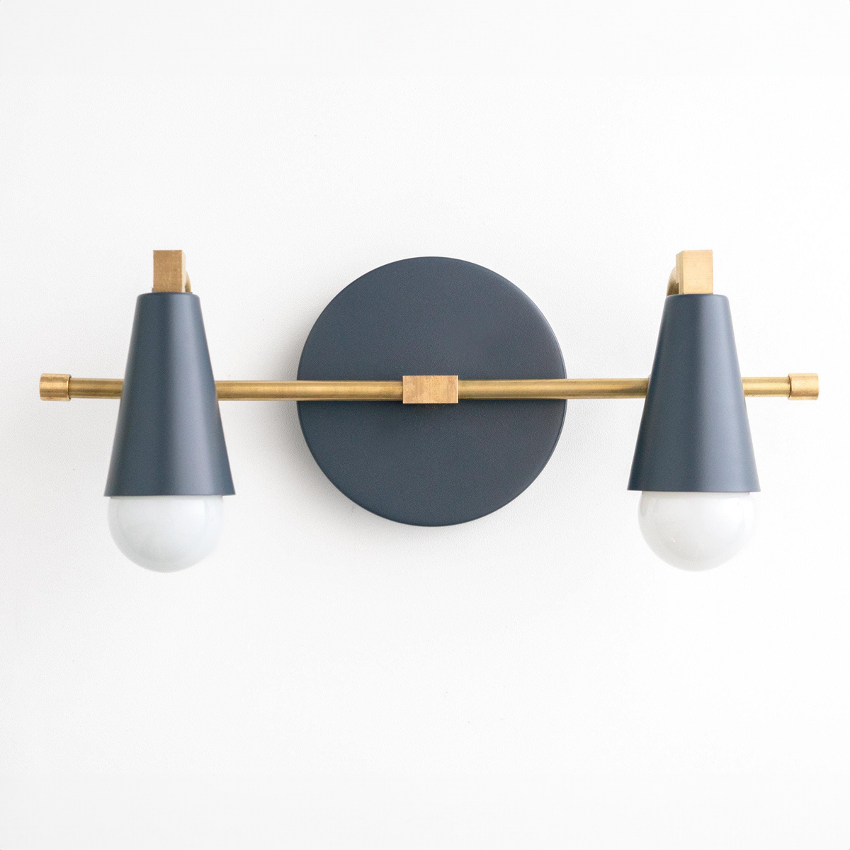 Industrial-style vanity light with matte black cone shades and brass accents, two exposed bulbs. - VANITY LIGHT MODEL NO. 1229