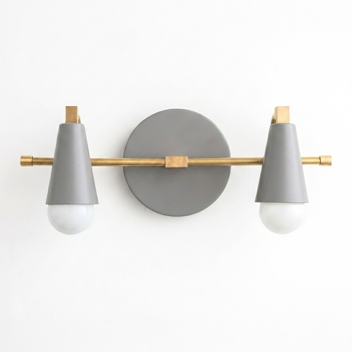 Scandinavian-style vanity light with two bare bulbs, matte gray cone shades, and brass accents. - VANITY LIGHT MODEL NO. 1229