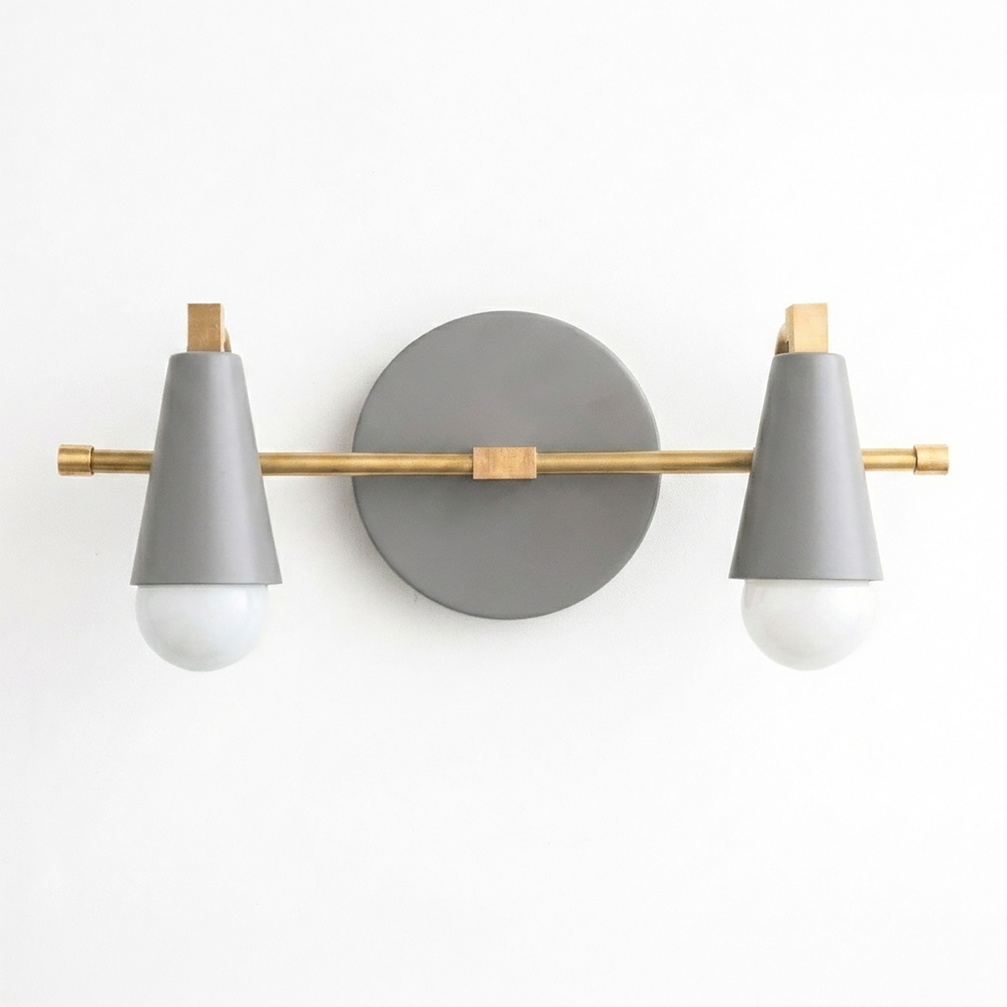 Scandinavian-style vanity light with two bare bulbs, matte gray cone shades, and brass accents. - VANITY LIGHT MODEL NO. 1229