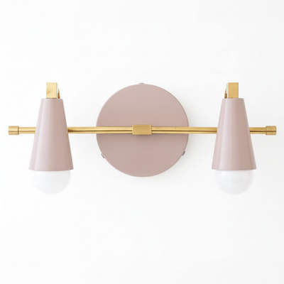 Two-bulb vanity light with matte pink conical shades and brushed brass horizontal bar on round pink backplate. - VANITY LIGHT MODEL NO. 1229
