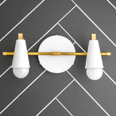 Modern industrial vanity light with a black metal base, horizontal gold rod, and two white cone shades covering bulbs. - VANITY LIGHT MODEL NO. 1229