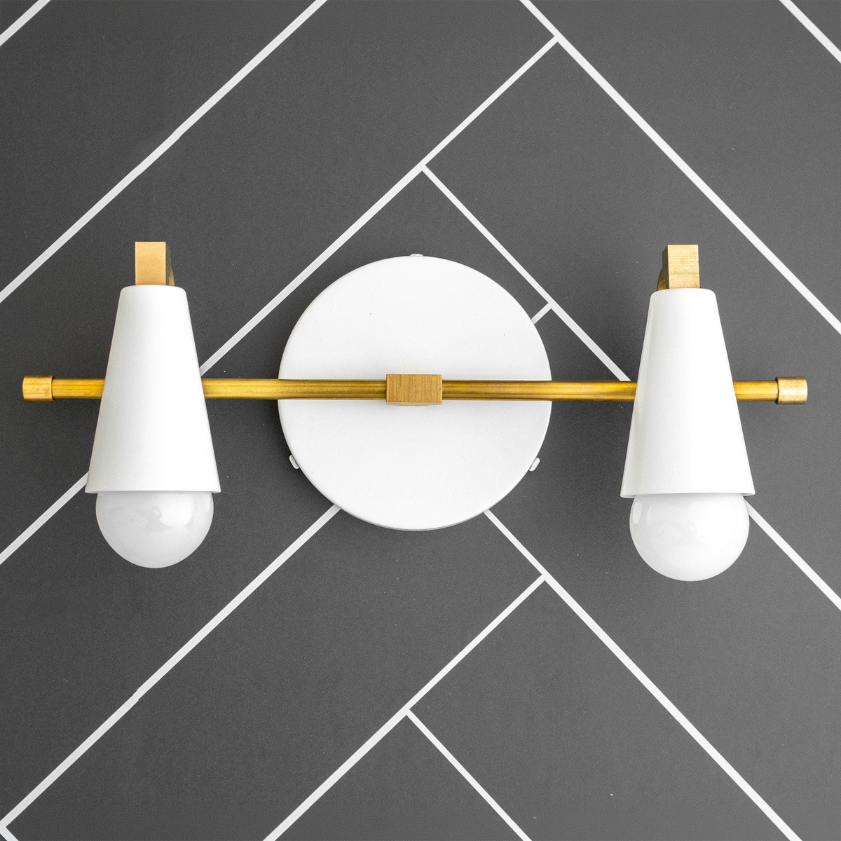 Scandinavian style 2-bulb vanity light with white cone shades and brass accents on round white base. - VANITY LIGHT MODEL NO. 1229